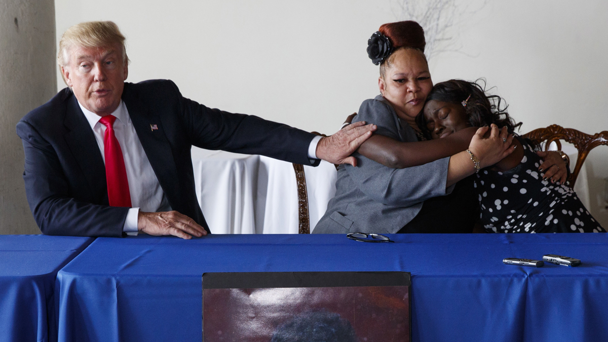 Republican presidential candidate Donald Trump comforts Shalga Hightower