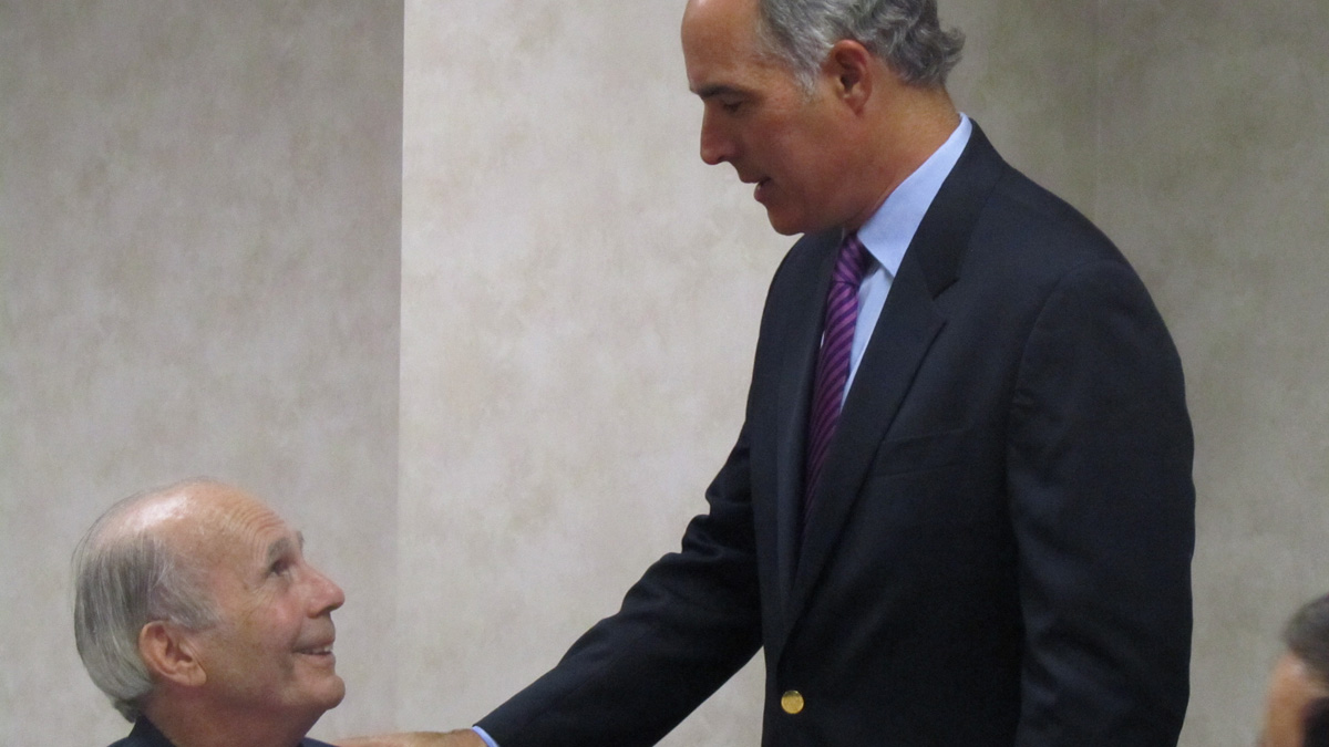  Senator Bob Casey greets colon cancer survivor Andy Lara at a Philadelphia roundtable discussion on research funding cuts.  (Maiken Scott/WHYY) 