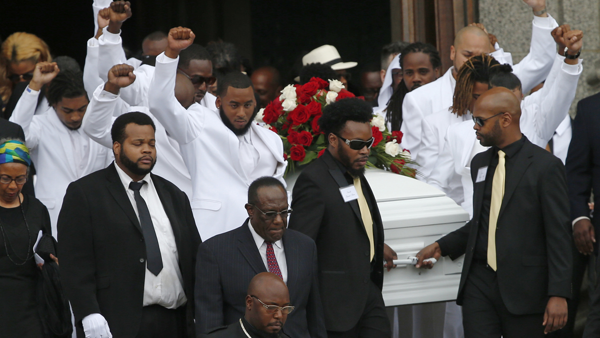 Pall bearers with fists raised carry the casket of  Philando Castile after his funeral service on Thursday