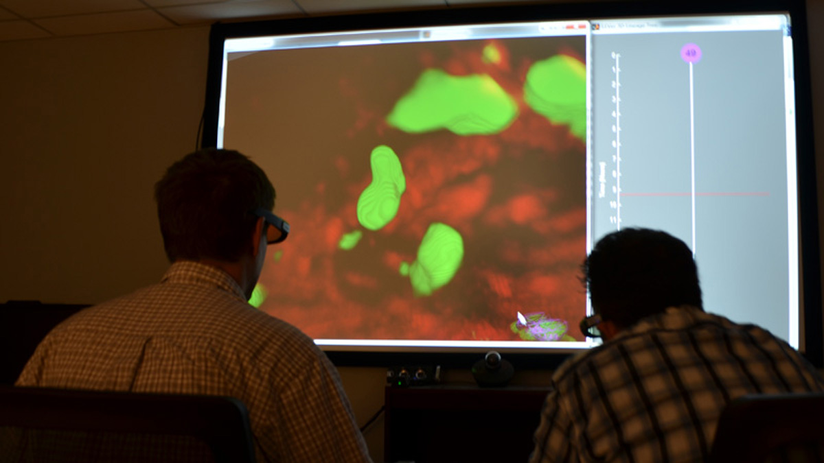  Andrew Cohen (right) works on a movie about cells with doctoral researcher Eric Wait (left). (Courtesy of Drexel University)  