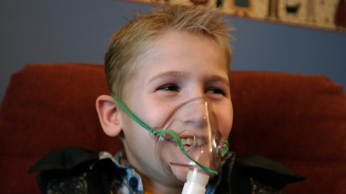 A cystic fibrosis patient receives one of his twice daily treatments for cystic fibrosis (AP Images