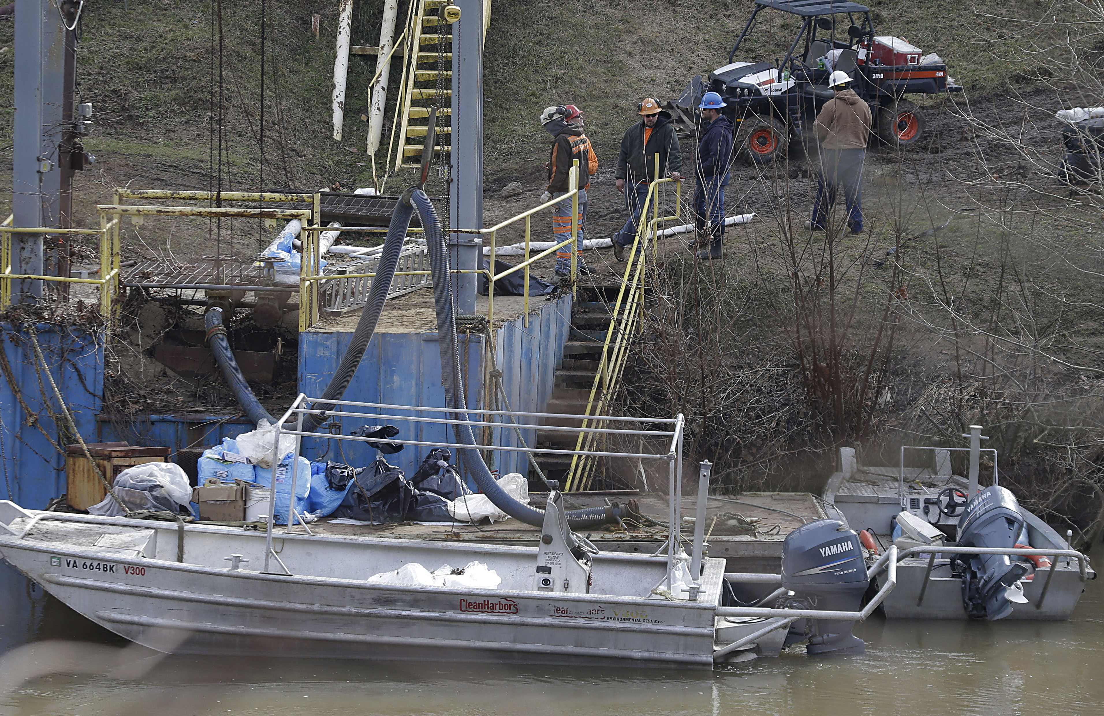  Workers at the Elk River, where a chemical leak left 300,000 without potable water for five days. (AP photo/Steve Helber) 