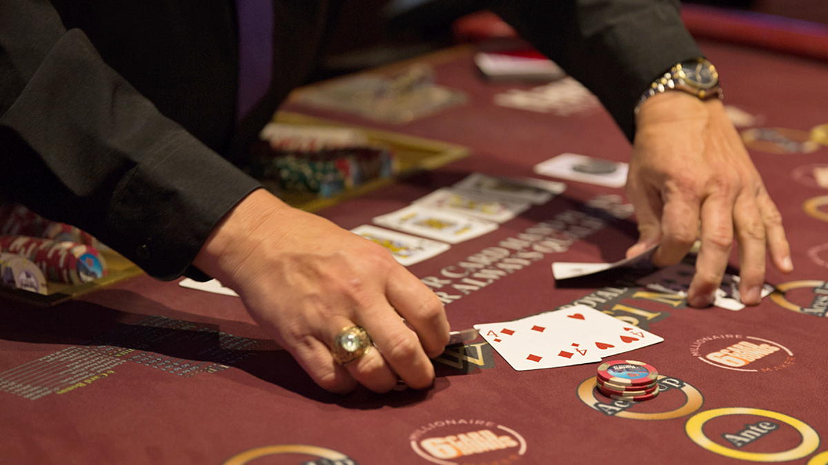  A dealer checks his hand in four card poker at Harrah’s Philadelphia Casino and Racetrack in Chester, Pa. (Lindsay Lazarski/WHYY) 