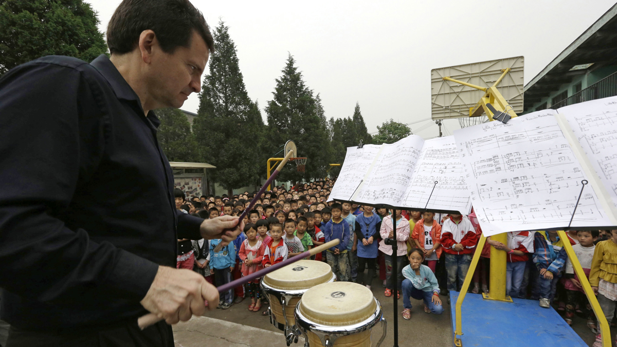 Christopher Deviney of the Philadelphia Orchestra performs as part of a outreach program to students at the Tongxin Experimental Primary School on the outskirts of Beijing