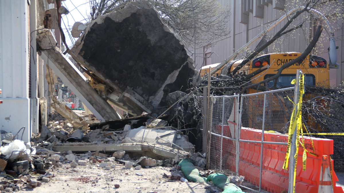 The wall of a building being demolished collapsed onto a school bus at Race and 5th Street. No one was injured. (Emma Lee/WHYY)