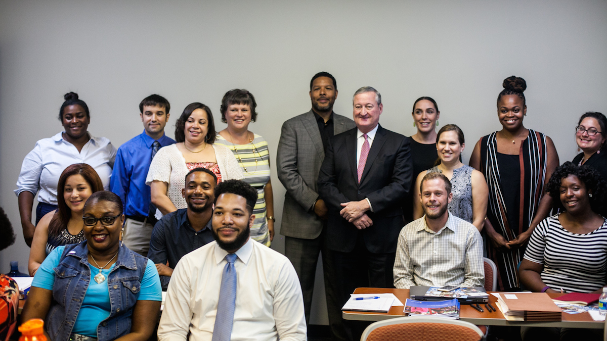 Mayor Jim Kenney poses with staff from new community schools set to open in a few weeks..(Brad Larrison for NewsWorks)