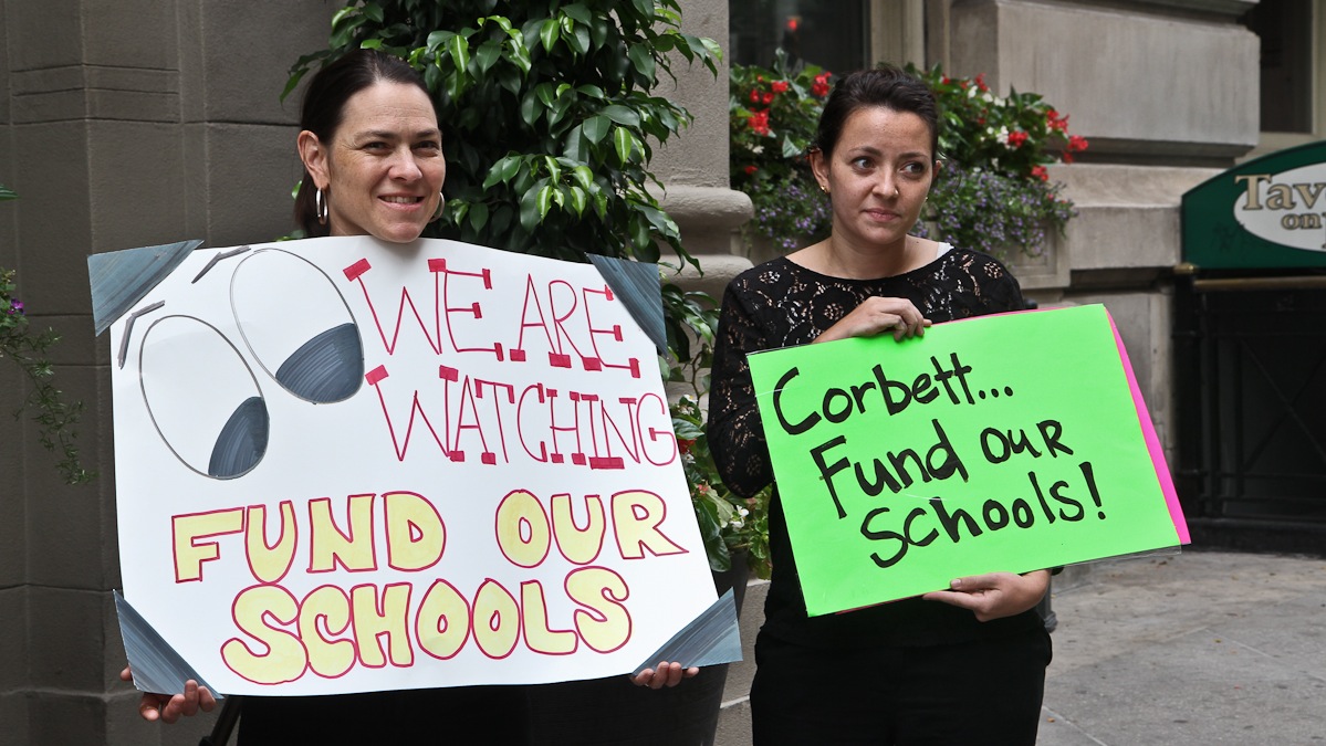 Parent Gretchen Elise Walker and former Philadelphia public school grad Erica Gendall-Conrad protest outside of Governor Corbett's office in Philadelphia. (Kimberly Paynter/WHYY)