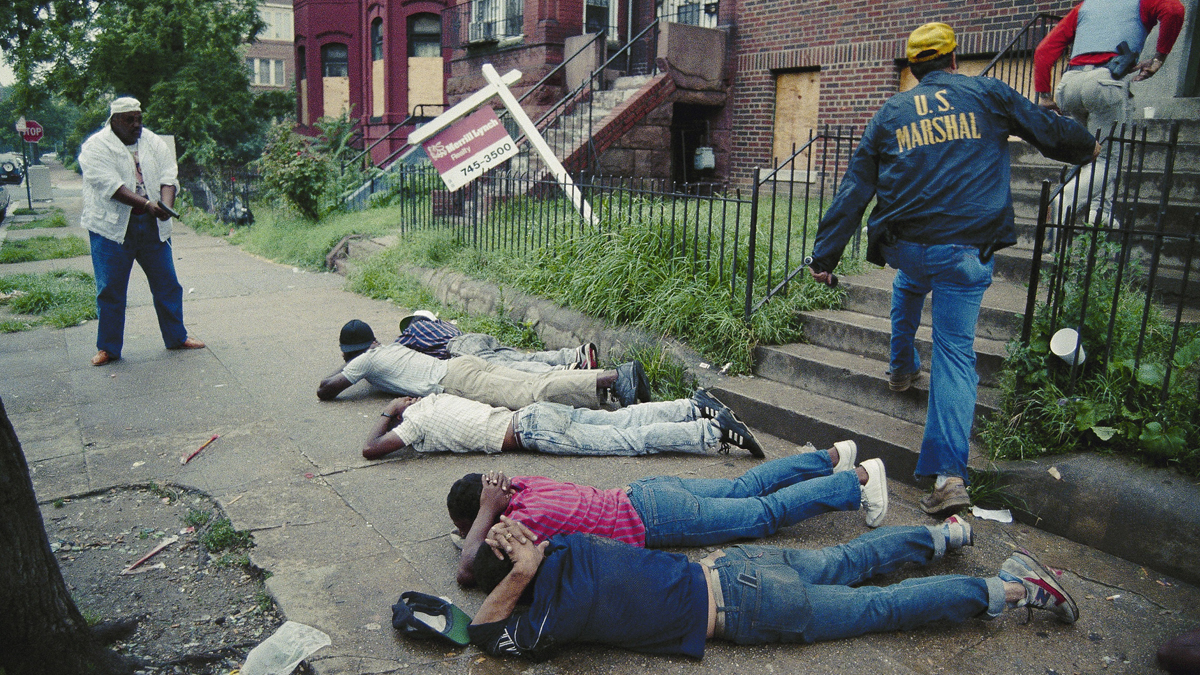  Attorney general Richard Thornburgh and Drug Czar William Bennett in Washington, July 17, 1989, released results of an eight week anti-drug initiative. Here, in photo taken during one of the raids, a U.S. Marshal, far left, keeps his pistol trained on suspects as other marshals raid a crackhouse. (AP Photo/Scott Applewhite) 