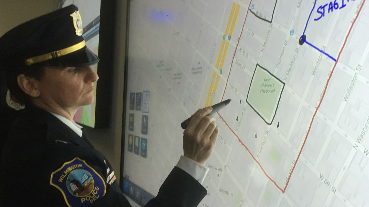 Cecilia Ashe writes on an interactive board in a crime center