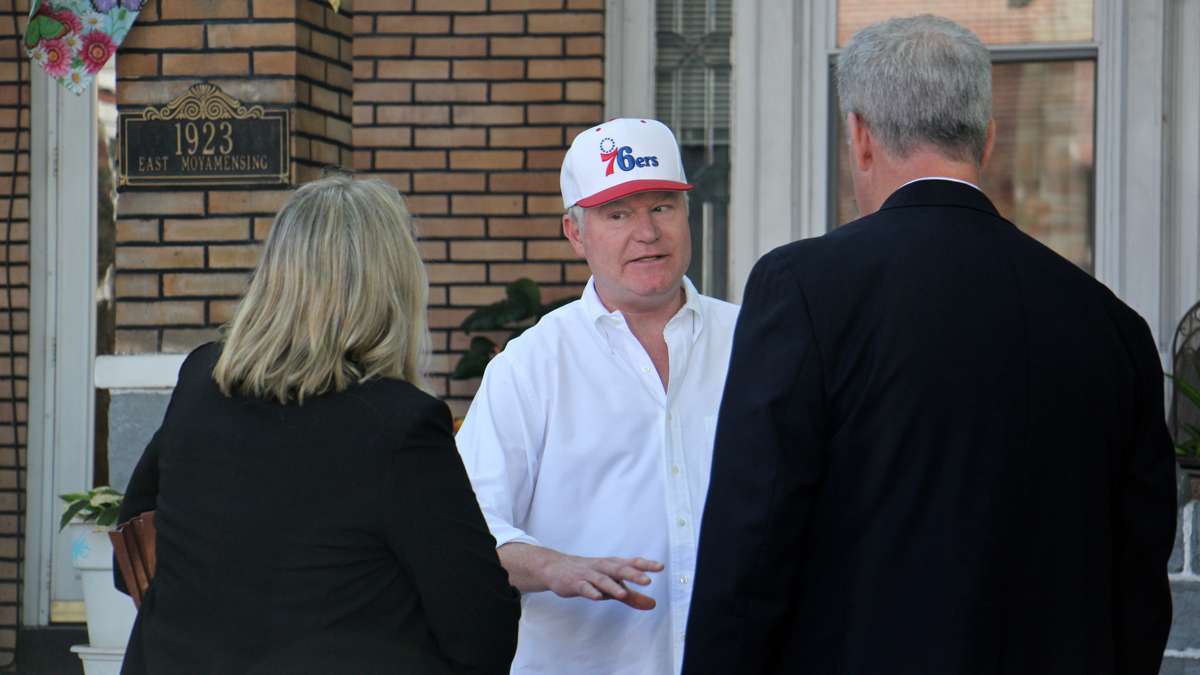 Union leader John Dougherty speaks with law enforcement as his home is searched Friday. (Emma Lee)