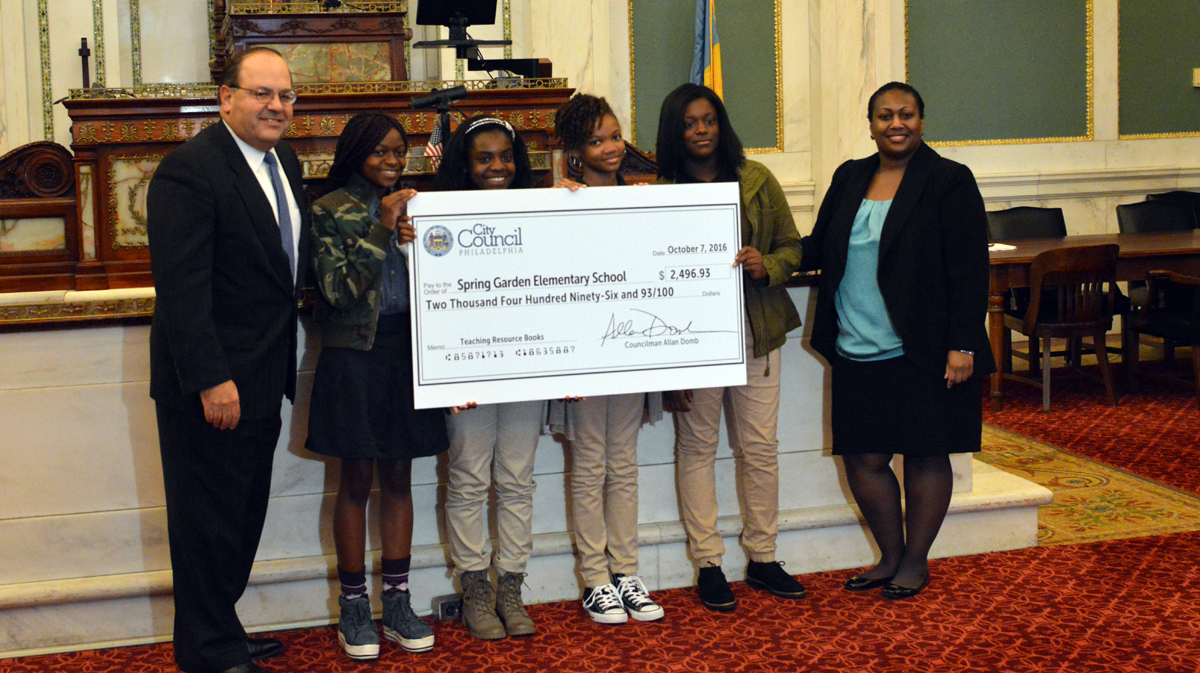 Philadelphia City Councilman Allan Domb stands with students from Spring Garden Elementary School