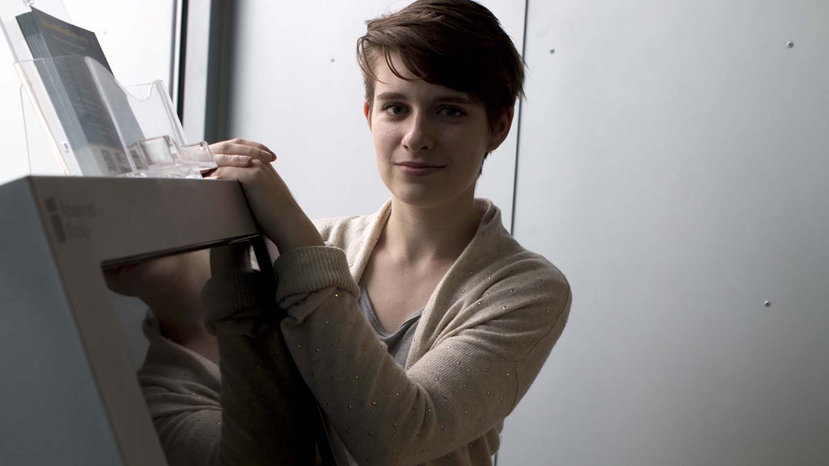  Anna Gibbons, a public health major at Drexel University,stands by the mental health screening kiosk. (Karen Shakerdge/ NewsWorks) 