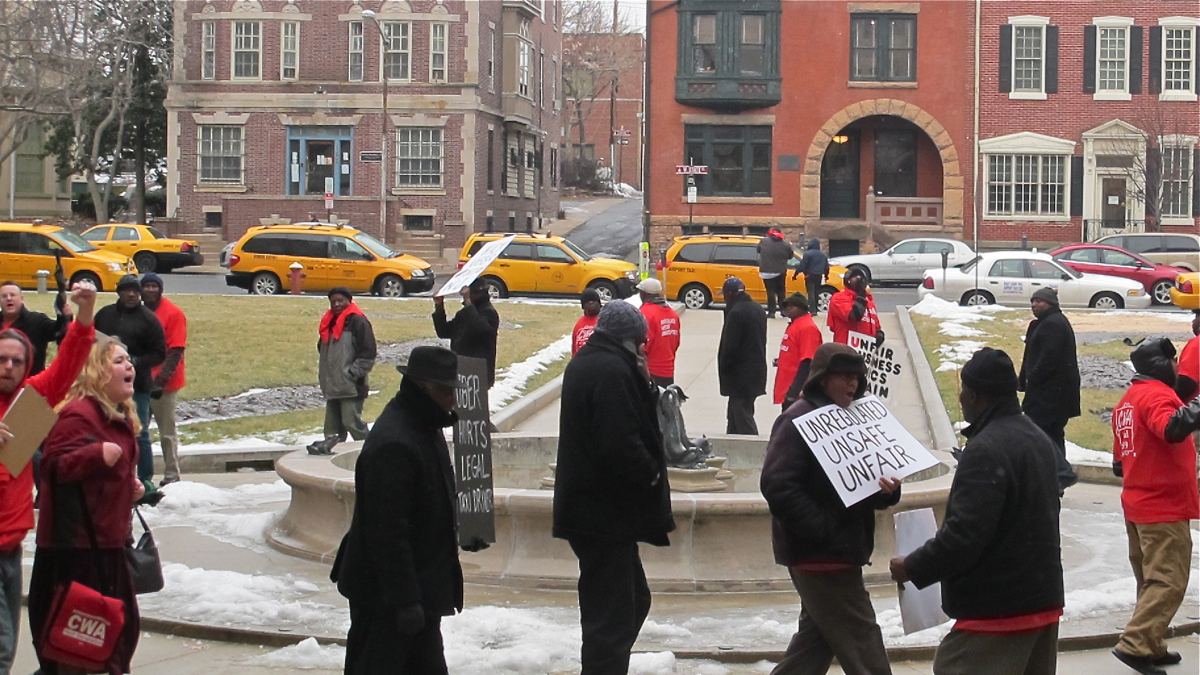  Taxi drivers demonstrate outside the New Jersey Statehouse as a Senate committee considers legislation to regulate Uber, Lyft, and other ride-sharing businesses. (Phil Gregory/WHYY) 