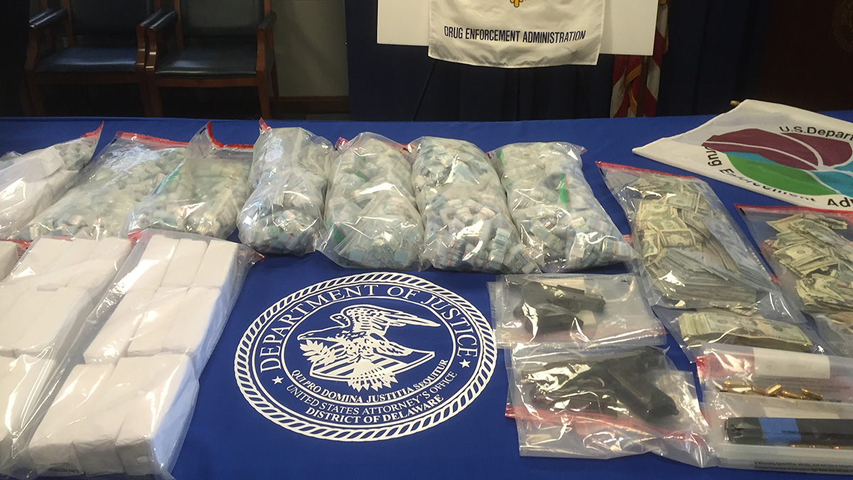   Officers seized 48,800 bags of pre-packed heroin, two loaded 9 mm handguns and $40,000 in cash from two addresses on Albe Drive in Newark. (Zoe Read/WHYY) 