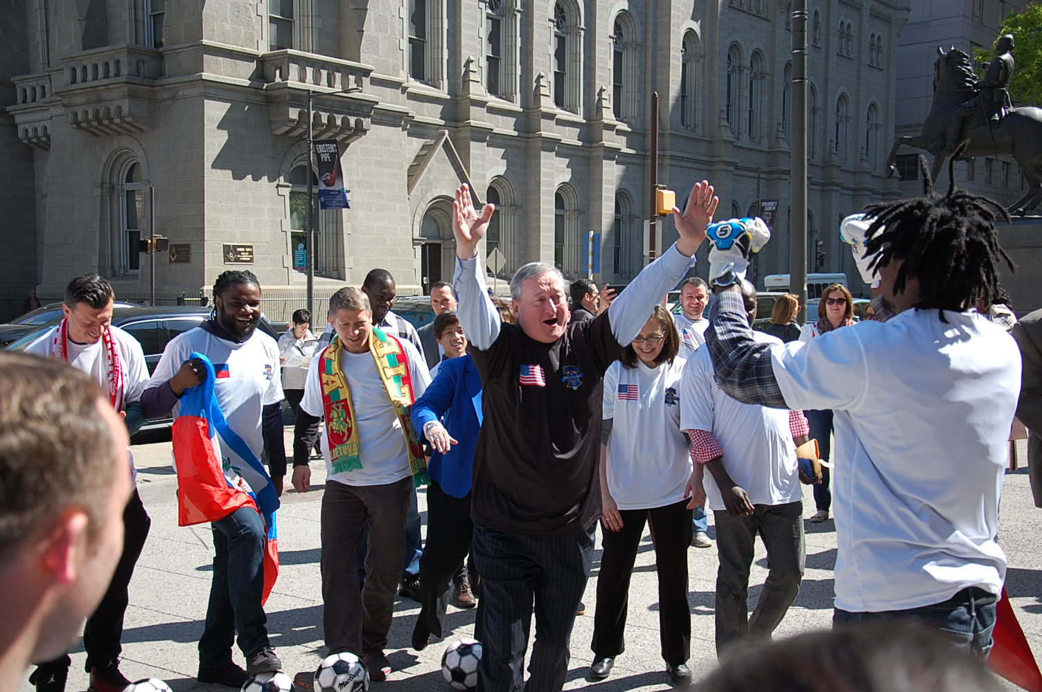 Mayor Jim Kenney celebrates scoring a goal with Unity Cup player. (Tom MacDonald/WHYY)