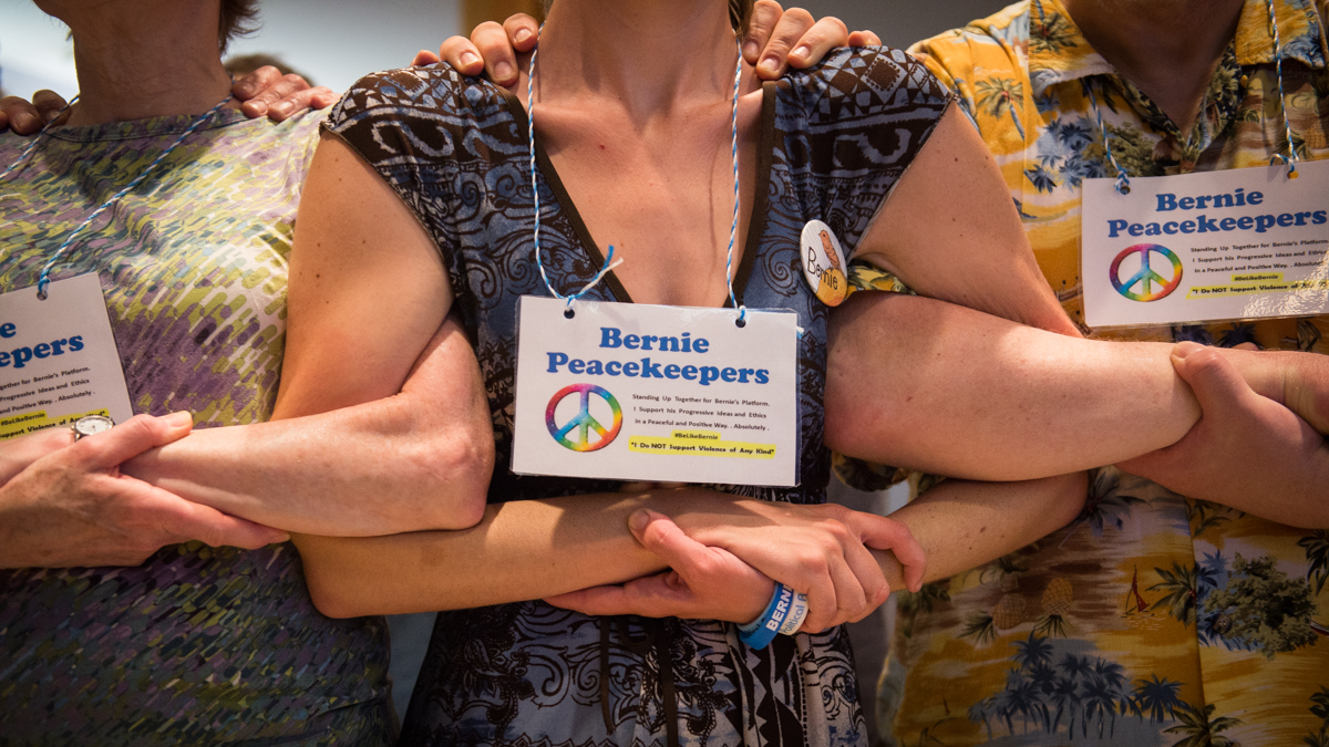 Bernie Peace Keepers link arms during a class on diffusing tension during protests in preparation for the Democratic National Convention. (Branden Eastwood For NewsWorks)