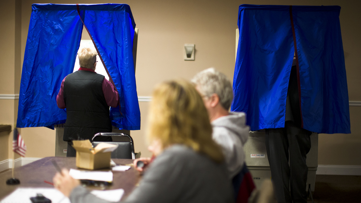  A voter steps into voting booth at the Oregon New Years Association in Philadelphia. An analysis of Department of State data shows turnout in Pennsylvania's struggling communities in 2010 was down nearly 20 percent from 1994. (AP Photo/Matt Rourke) 