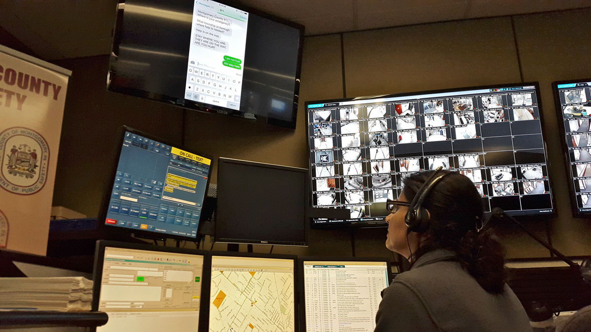  A call center operator monitors screens at Montgomery County Emergency Services Center, which now include text messages to 911. (Laura Benshoff/WHYY) 