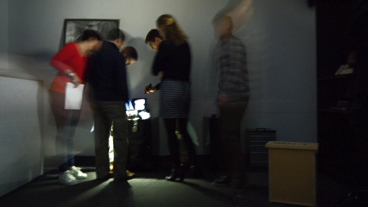 The group tries to solve puzzles to escape the room. (Charlie Kaier/WHYY)