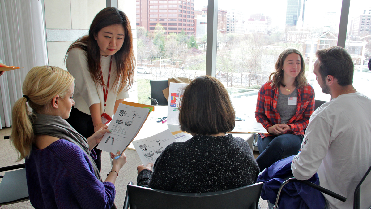 Min Soo Yoo gives her refugee students a feel for an immigrant's English as a second language class by teaching them Korean. (Emma Lee/WHYY)
