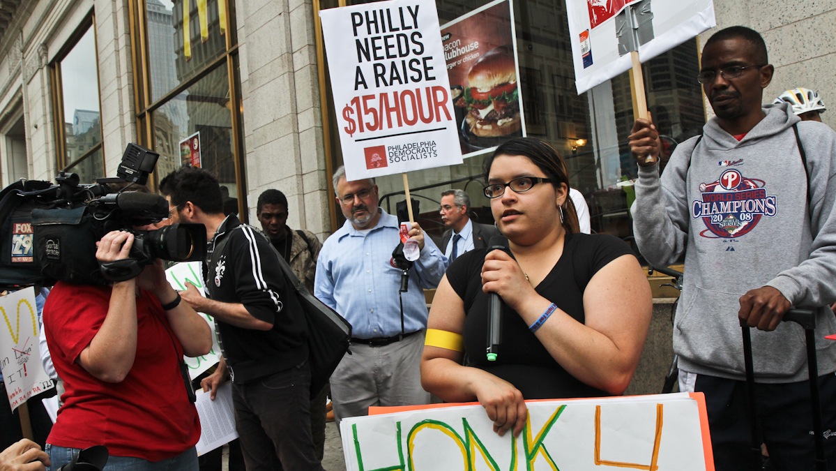  Crystal Lopez, who works at a Dunkin Donuts/Baskin Robbins and says it's impossible to support her sick mother and 11 year-old brother on a minimum wage salary, is shown at a protest outside of a Center City Philadelphia McDonald's demonstrating for a $15/hour minimum wage. (Kimberly Paynter/WHYY) 