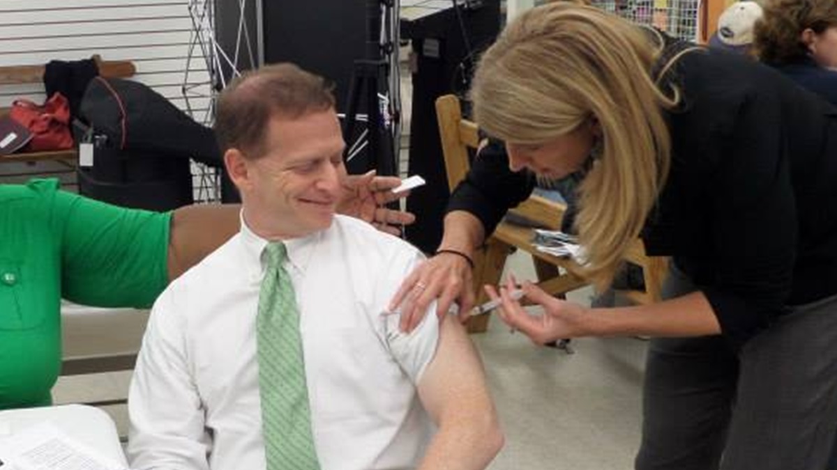 DPH Director Dr. Karyl Rattay gives Lt. Gov. Matt Denn his flu shot. (photo courtesy DHSS) 