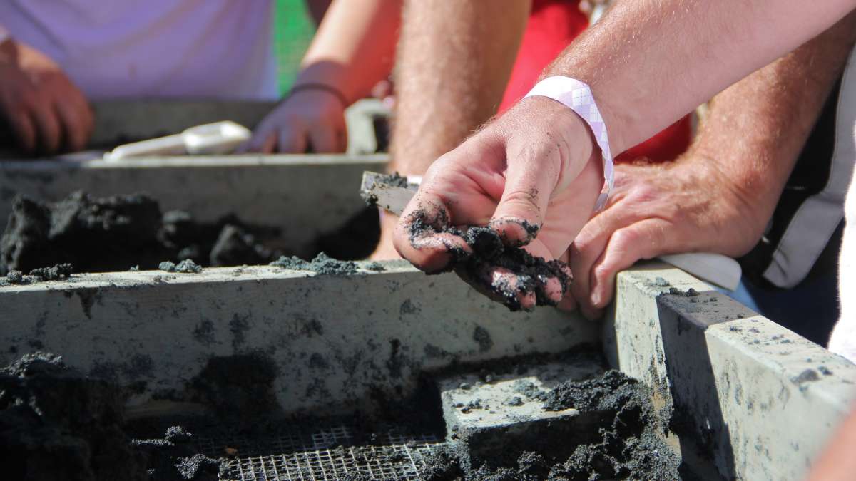 Eager hands sift through dirt, searching for shells and teeth and fragments of bones during a community dig day at the Mantua Township fossil site. (Emma Lee/WHYY) 