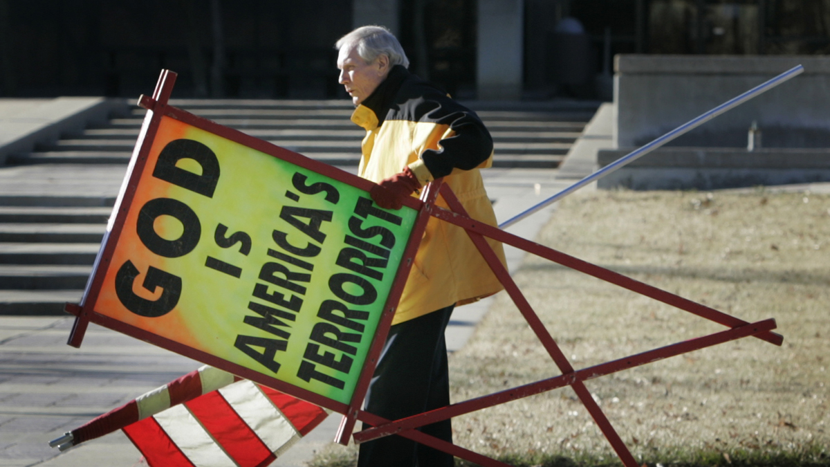  In this July 1, 2007 file photo, the Rev. Fred Phelps Sr. prepares to protest outside the Kansas Statehouse in Topeka, Kan. Phelps, the founder of the Kansas church known for anti-gay protests and pickets at military funerals, died late Wednesday, March 19, 2014, his family said. He was 84. (AP Photo/Orlin Wagner, File) 