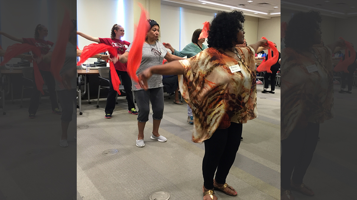 Women attending Camp Discovery learn Bollywood dance moves. The women