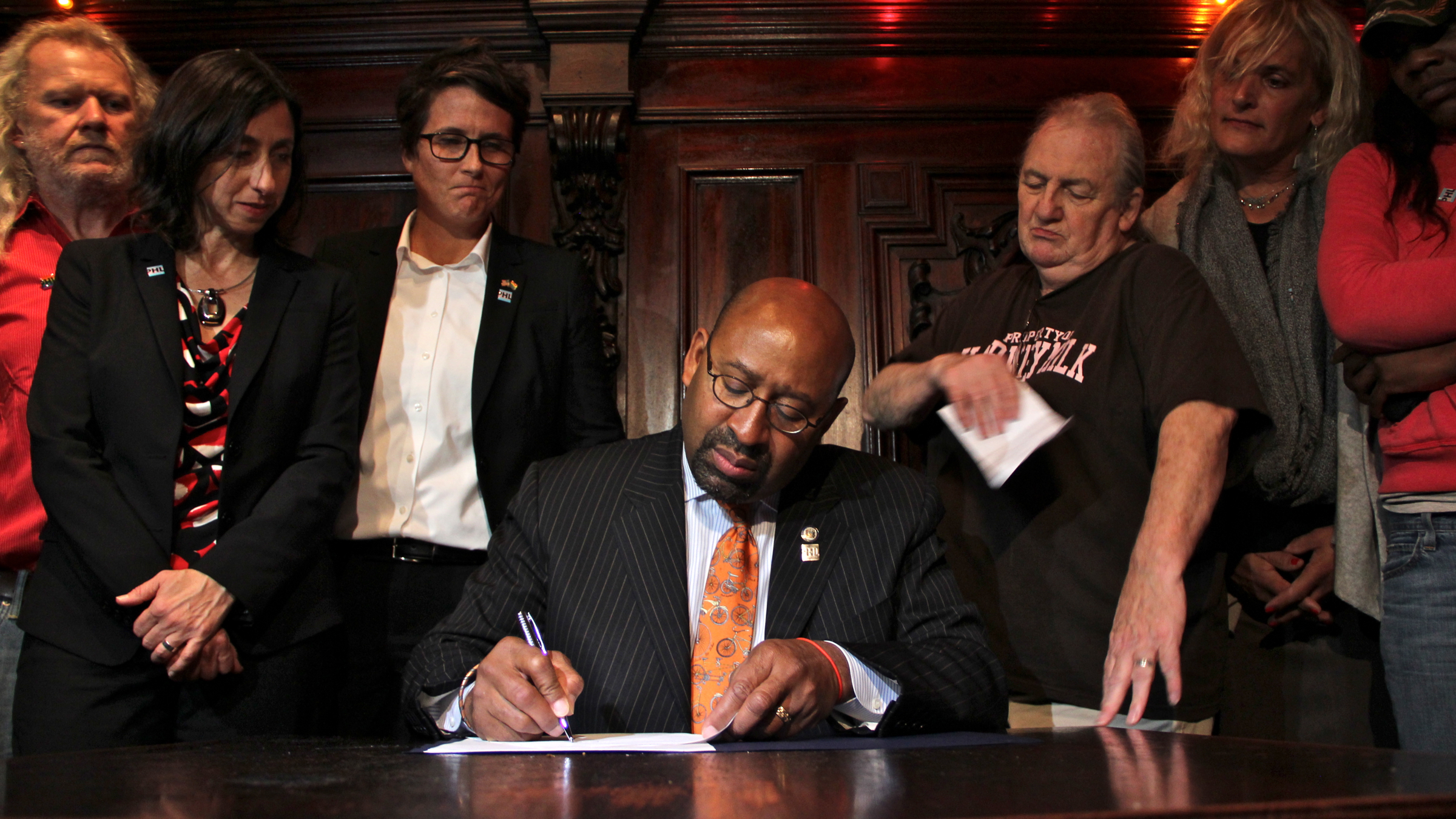  Mayor Michael Nutter signs a law banning gender signs on single-user bathrooms. The act was applauded by members of the city's trans gender communities. (Emma Lee/WHYY) 