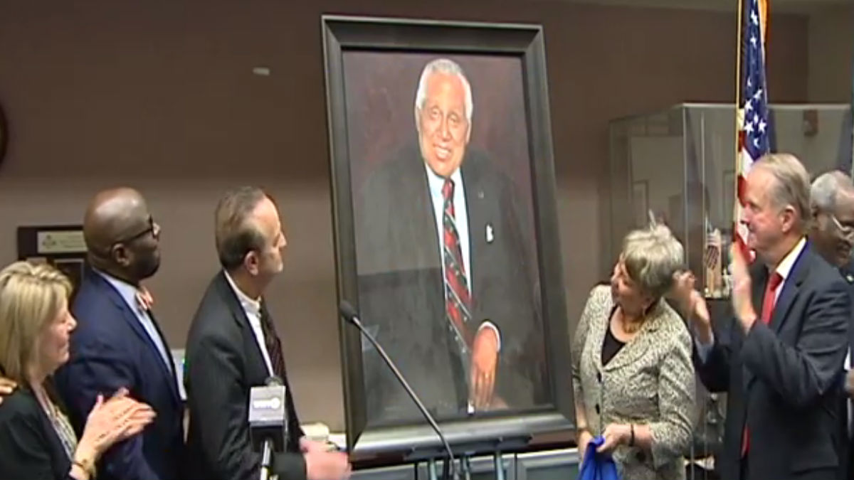 The late James Gilliam's portrait is unveiled at the New Castle County Community Service Building that bears his name. (Charlie O'Neill/WHYY)