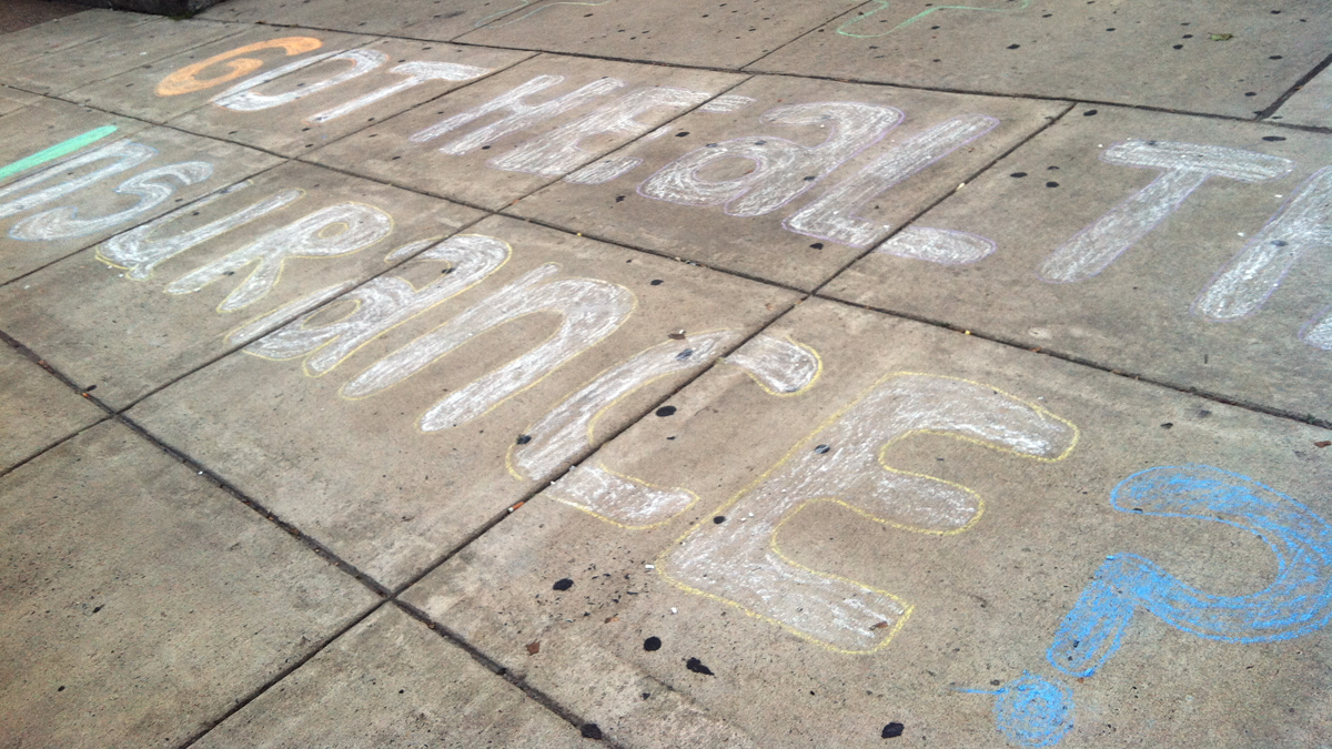  Got health Insurance? This chalk sign appeared on a sidewalk outside a recent public forum about the new Pa. health insurance marketplace. Philadelphians can expect to see on-th-ground application counselors when the exchange launches. (Elana Gordon/WHYY) 