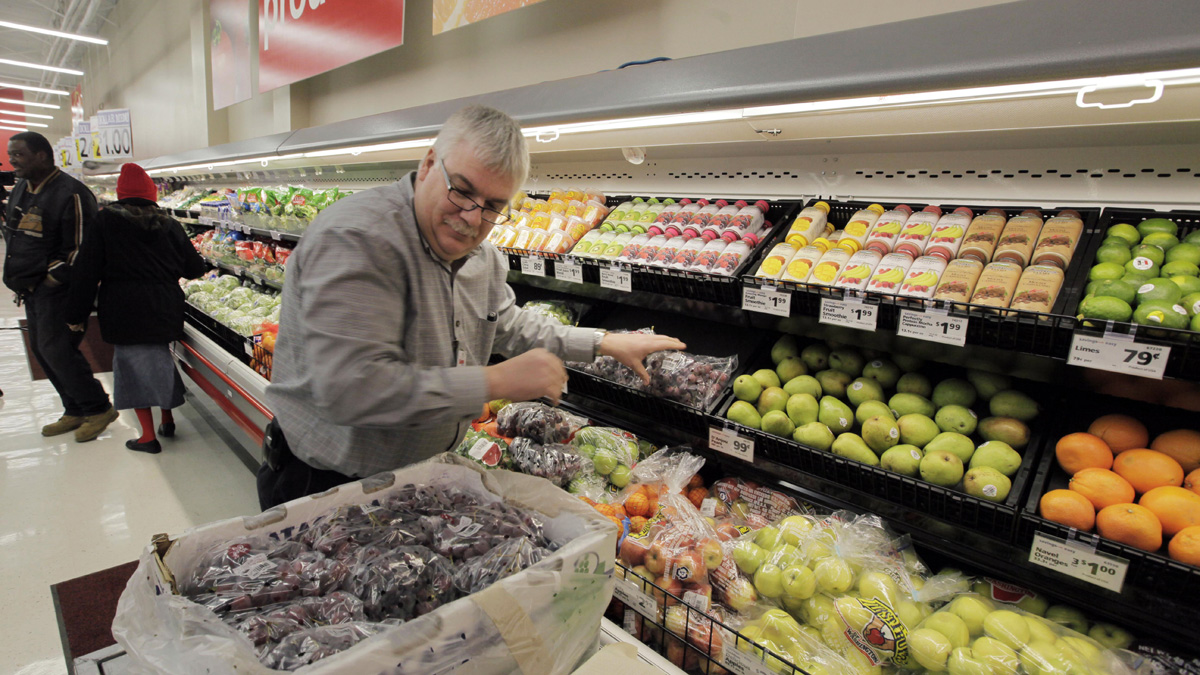  A Save-A-Lot Food Store employee is shown stocking produce at a store in Chicago's south side. The store was one of five that opened in the area in an effort to bring healthy food choices to families who have not had access to nutritious foods. A new study challenges that premise. (AP Photo/M. Spencer Green, file) 