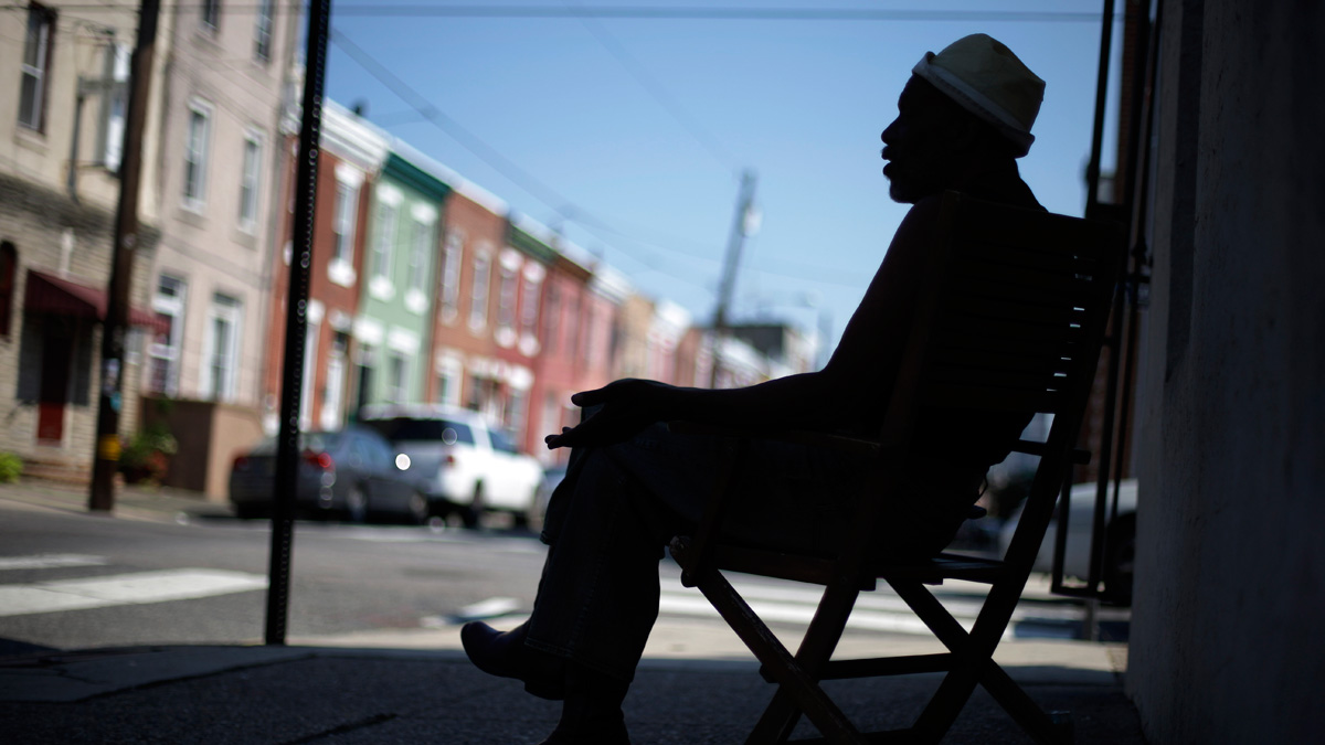 Scoe sits in the shade avoiding the heat of the sun near his home Wednesday