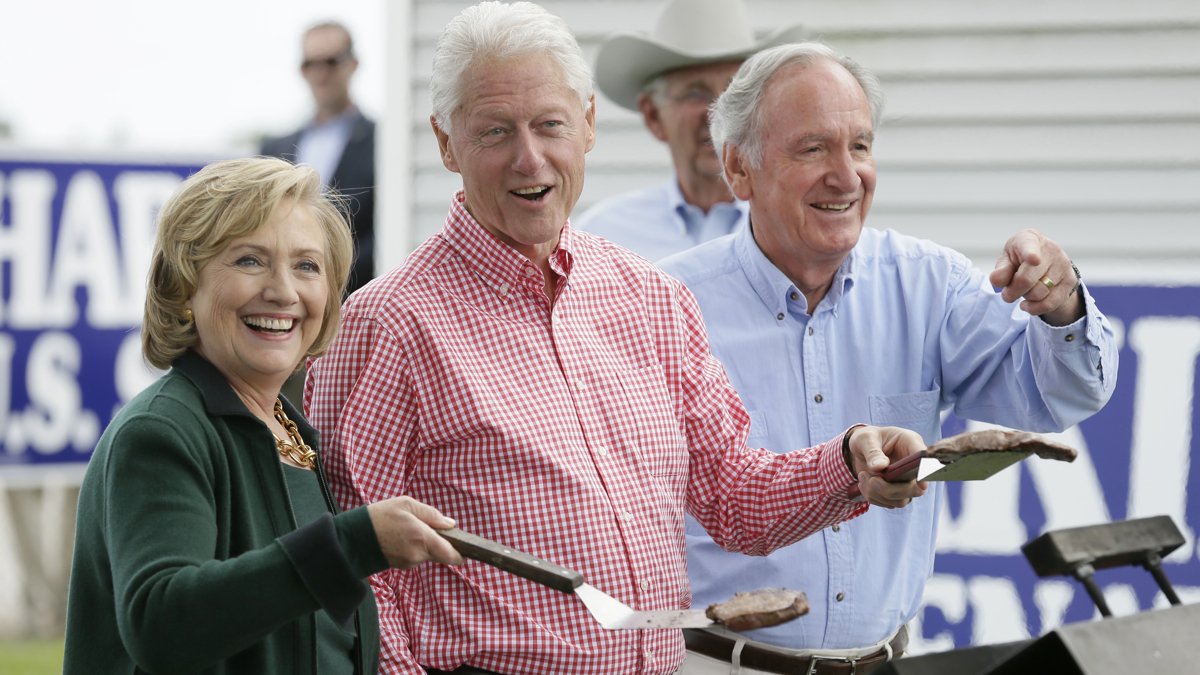  Former Sec. of State Hillary Rodham Clinton, former President Bill Clinton and U.S. Sen. Tom Harkin work the grill during Harkin's annual fundraising Steak Fry Sunday, in Indianola, Iowa. (AP Photo/Charlie Neibergall) 