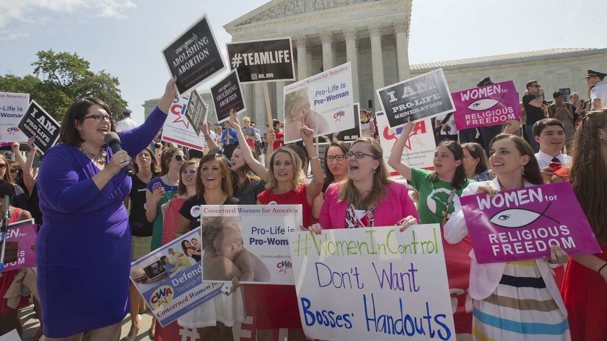  Kristin Hughs, left, is shown announcing to supporters the Supreme Court's decision on the Hobby Lobby case in Washington, on Monday, June 30, 2014. (AP Photo/Pablo Martinez Monsivais) 