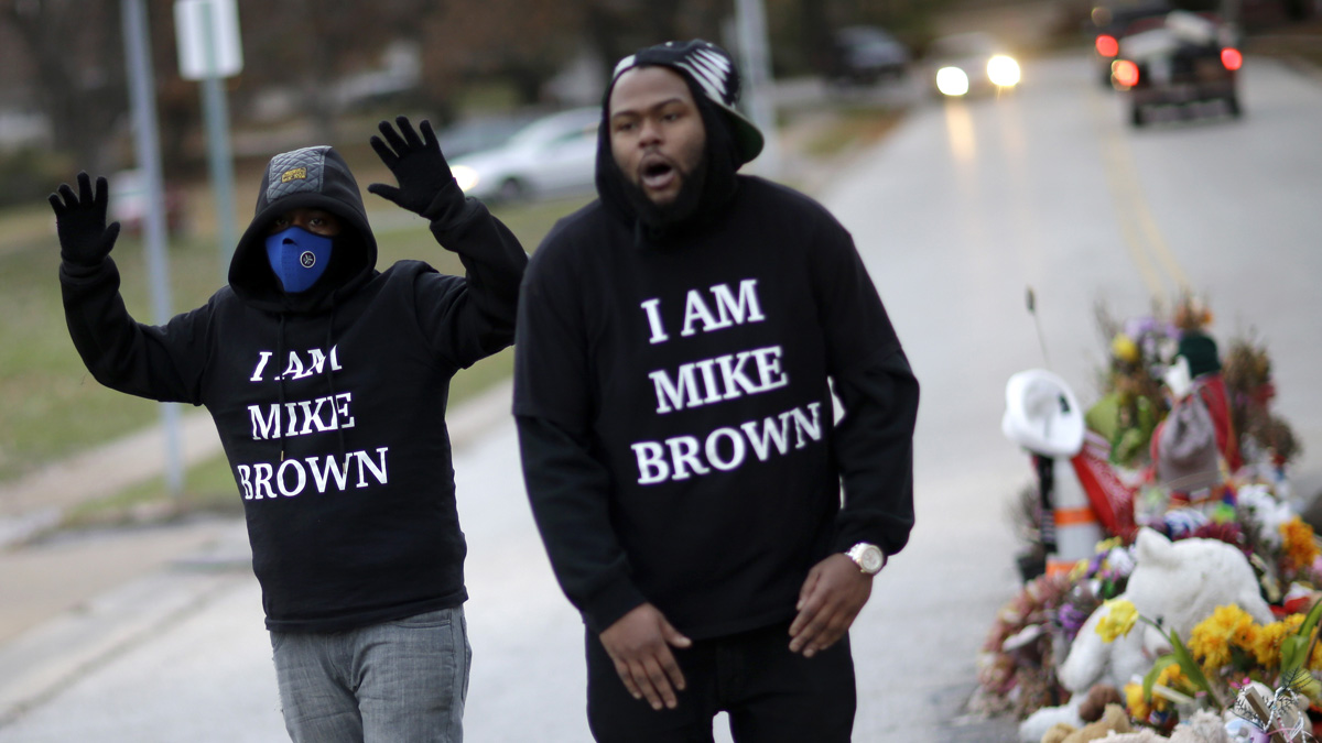  Protesters gather near a memorial in the middle of the street in Ferguson, Missouri, on Nov. 24, 2014, more than three months after a white policeman shot and killed Michael Brown, a black 18-year-old man, there. A grand jury later that night released its decision not to indict the the police officer. (AP Photo/David Goldman) 