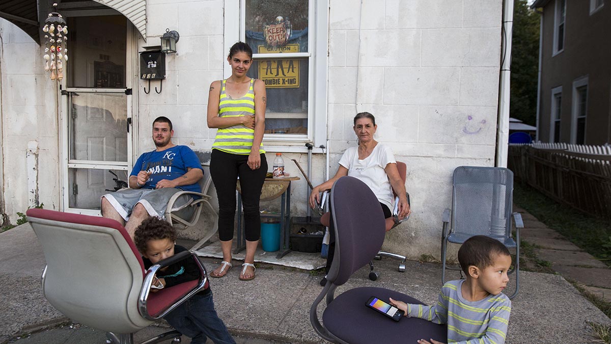  From left to right: Anthony Petraline, 22, Crystel Petraline, 27, Mary Petraline,52, with Mason, 4, and Liam, 3, in front of their home near one of the boundaries for the 7th and the 13th districts in Norristown, Pennsylvania. Crystel and Mary said they plan on voting for Hillary Clinton. “Her being about children will definitely benefit us,” said Crystel. (Lindsay Lazarski/WHYY) 