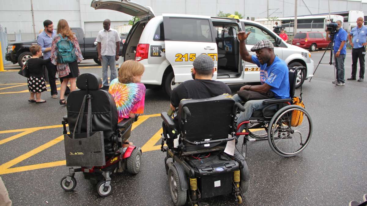  Accessibility activists gather round as Philadelphia introduces new wheelchair accessible taxis. (Emma Lee/WHYY) 