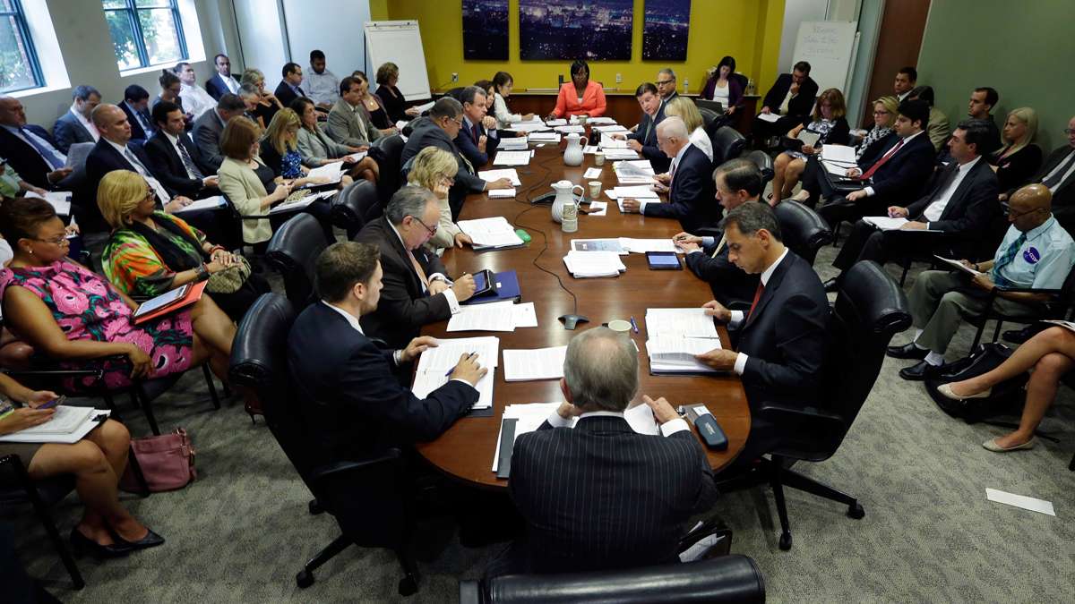 Former Camden Mayor Dana Redd, left, listens during a meeting of the New Jersey Economic Development Authority Thursday, July 10, 2014, in Trenton, N.J., where a vote was taken on a $260 million tax break was approved for Holtec International. (Mel Evans/AP)