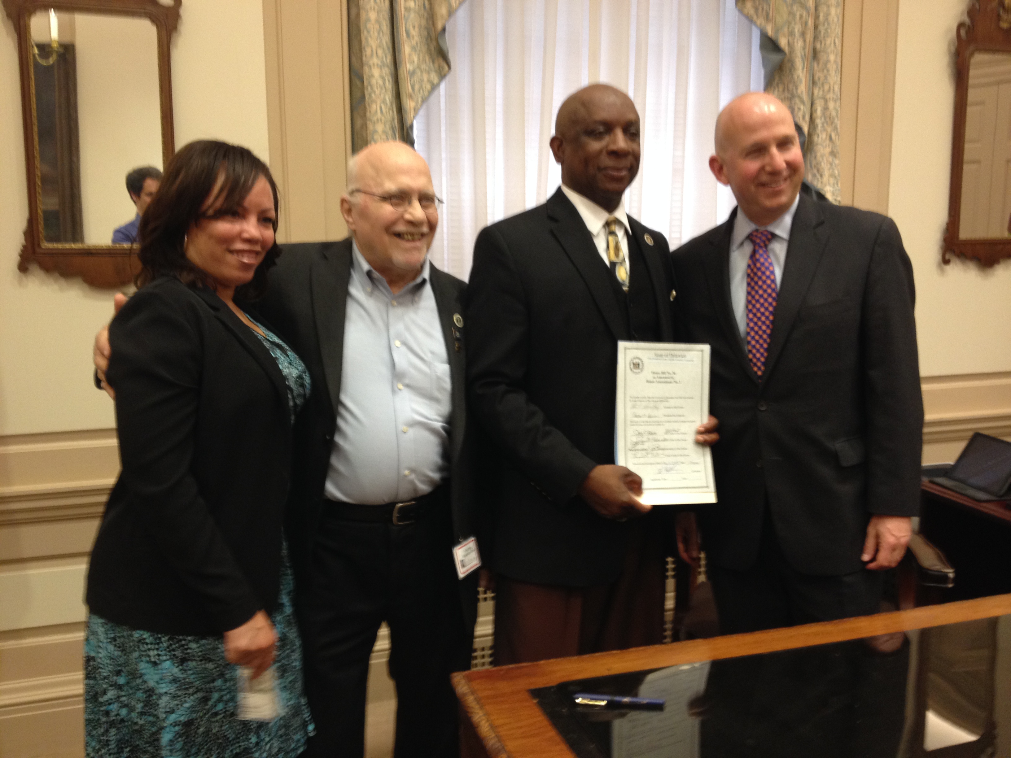  Representative Charles Potter Jr. (second from right) poses with Governor Jack Markell (far right) at the signing ceremony for House Bill 56. (Avi Wolfman-Arent, NewsWorks) 