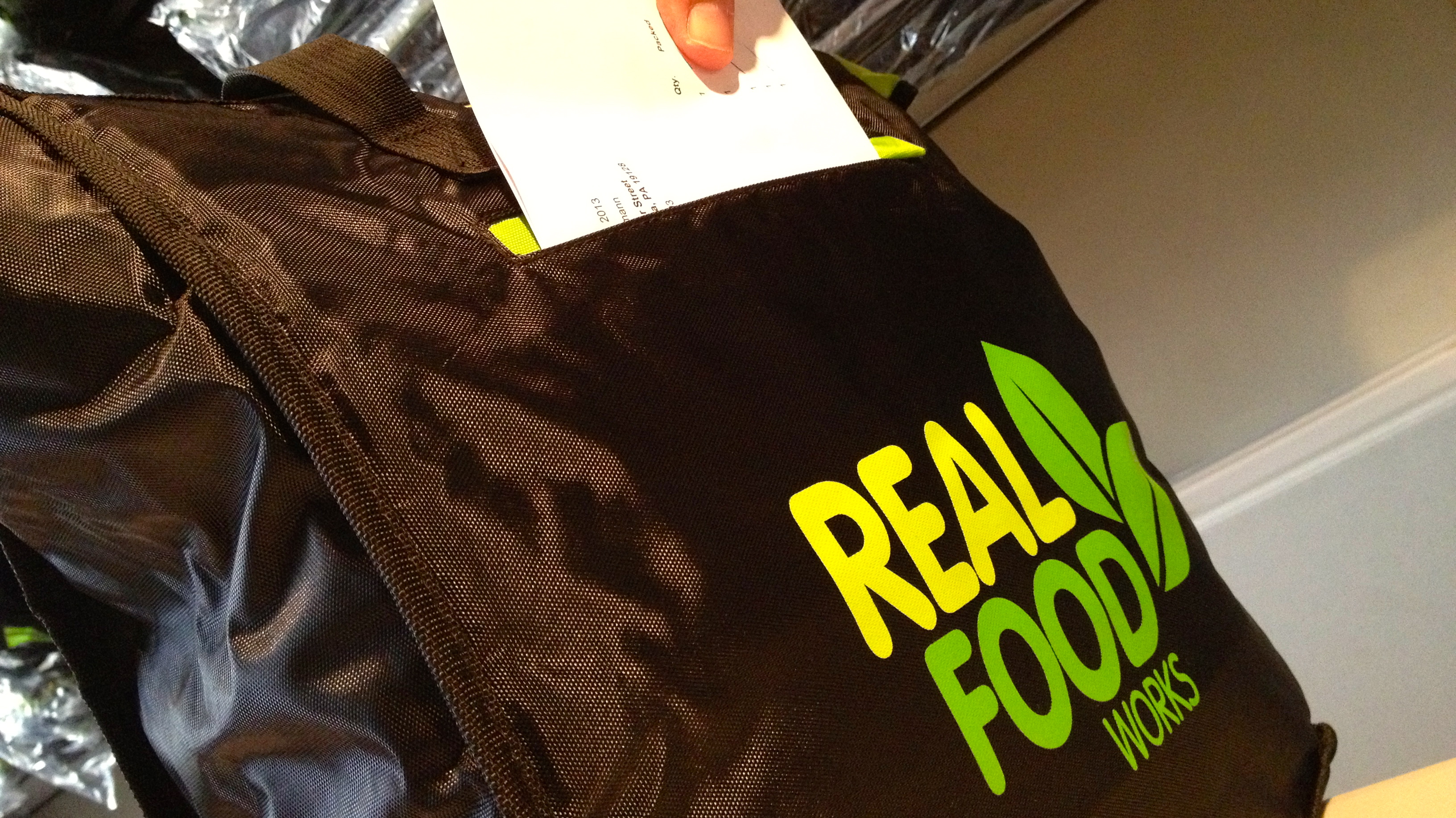  Workers pack a Real Food Works delivery bag at the startup's Center City headquarters. (Zack Seward/WHYY, file) 