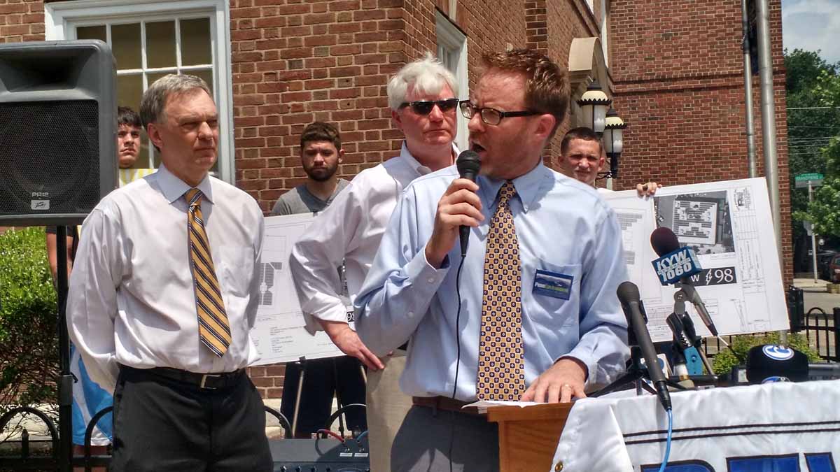  David Masur, center, executive director of PennEnvironment, speaks at a news conference in Philadelphia calling on state lawmakers to boost funding for solar energy. He is flanked by Pennsylvania Secretary of Policy and Planning John Hanger, left, and electricians union leader John Dougherty. (Katie Colaneri/WHYY) 