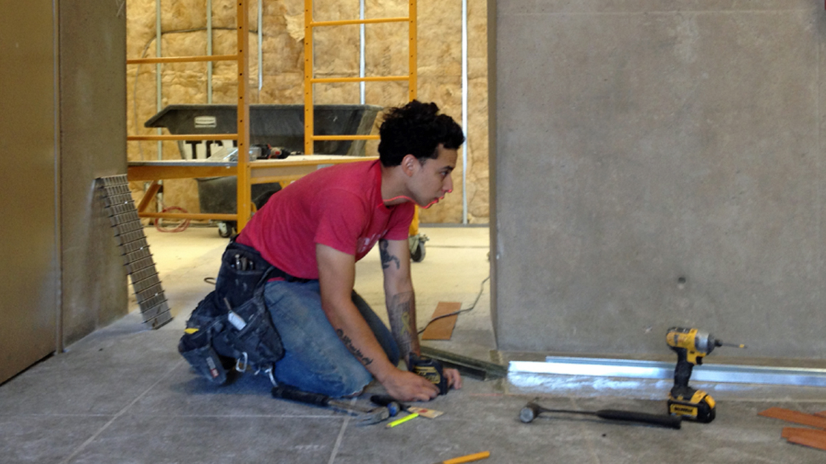  Joel Guevara builds a closet space on his last day as a carpenter. Guevara is one of 19 students in the first class of Zip Code Wilmington. (Avi Wolfman-Arent/WHYY) 