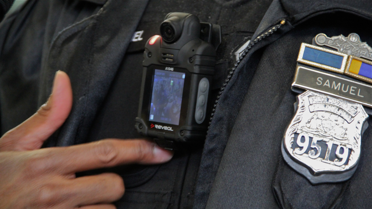 Officer James Samuel turns on a body camera with a small video display. (Emma Lee/WHYY)