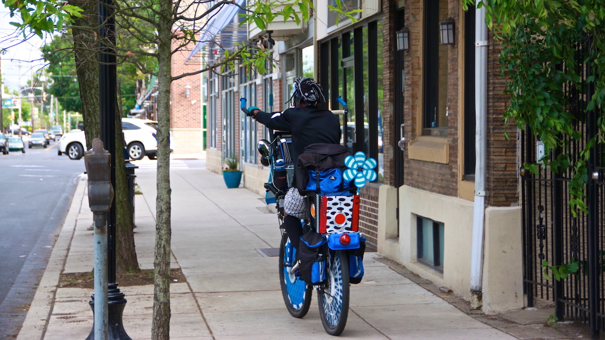  Cecil Degarr riding away on one of his bikes. (Courtesy of Michael George Advertising) 
