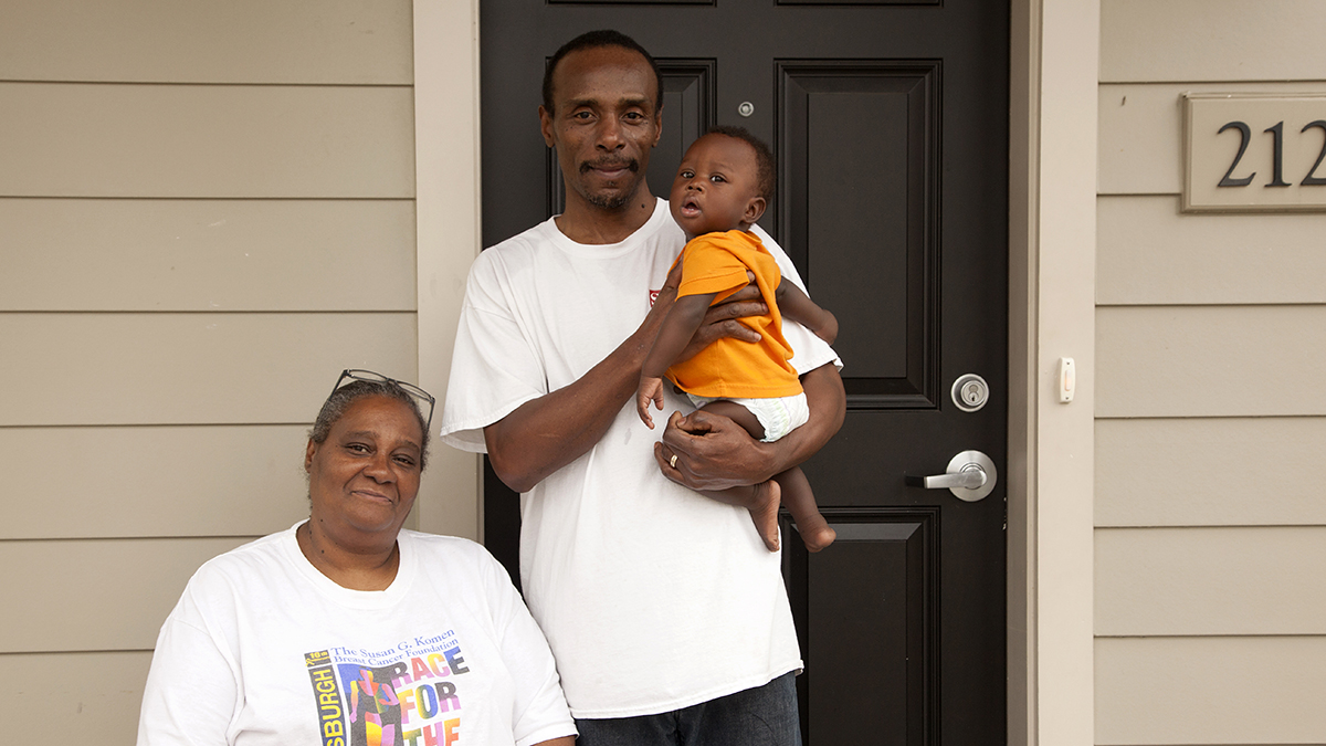  Selena and James Strothers with their grandson, in front of their new home in the Skyline Terrace redevelopment in Pittsburgh. (Irina Zhorov/Keystone Crossroads) 