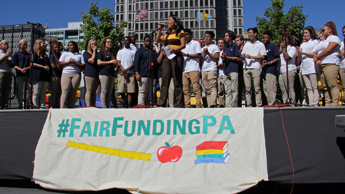Philadelphia City Councilwoman Helen Gym takes the stage with the Girard Academic Music Program singers at Dilworth Park