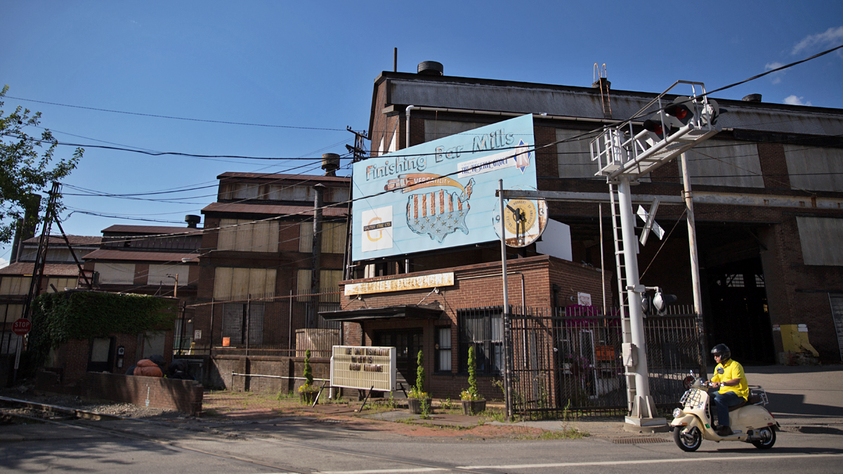 A motorcyclist rides by the former site of the Cambria Iron Company and Bethlehem Steel in Johnstown