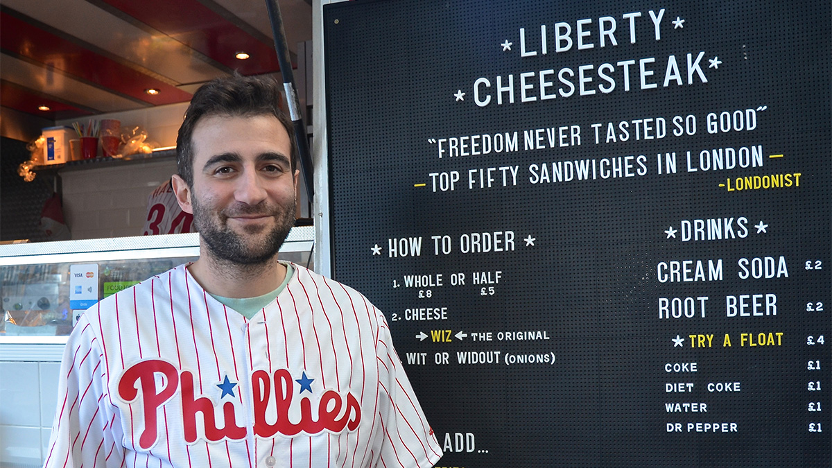 JP Teti posing in front of his Liberty Cheesesteak truck in London's historic Old Spitalfield's Market (Linn Washington Jr./for NewsWorks)